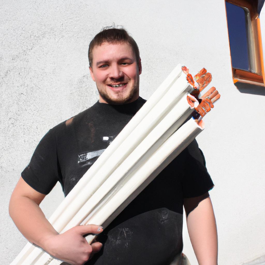 Person holding construction materials, smiling